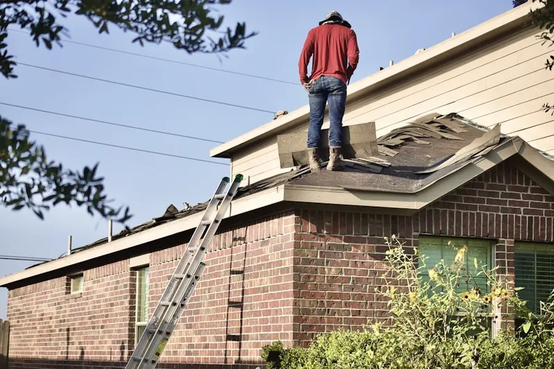 Professional roofer working on a residential roof in Bishop Wood